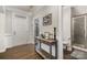 Inviting foyer with hardwood floors, white door and bathroom access at 3332 Katherine Taylor Ct, Monroe, NC 28110
