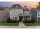 Beautiful two-story home featuring a covered entrance, lush landscaping, and serene twilight setting at 3332 Katherine Taylor Ct, Monroe, NC 28110