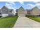 Inviting two-story home featuring a two-car garage and a well-maintained lawn with a long driveway at 3332 Katherine Taylor Ct, Monroe, NC 28110