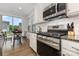 Modern kitchen featuring stainless steel appliances, granite countertops, and a view to the dining area at 3332 Katherine Taylor Ct, Monroe, NC 28110