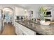 Kitchen island features granite countertops, stainless steel sink and white cabinets at 3332 Katherine Taylor Ct, Monroe, NC 28110