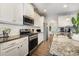 Modern kitchen with granite countertops, subway tile backsplash, and stainless steel appliances at 3332 Katherine Taylor Ct, Monroe, NC 28110