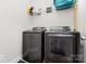 The laundry room features a front load washer and dryer and shelving at 3332 Katherine Taylor Ct, Monroe, NC 28110