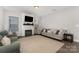 Bright living room featuring an electric fireplace, shiplap accent wall and modern furnishings at 3332 Katherine Taylor Ct, Monroe, NC 28110