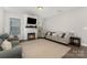 Bright living room featuring an electric fireplace, shiplap accent wall and modern furnishings at 3332 Katherine Taylor Ct, Monroe, NC 28110
