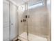 A beautifully tiled shower with glass doors features a built-in seat and toiletry shelf at 3332 Katherine Taylor Ct, Monroe, NC 28110