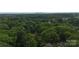 Aerial view of the property with surrounding trees and foliage, with a skyline view in the distance at 3519 Campbell Dr, Charlotte, NC 28205