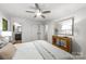 Calm bedroom featuring soft, neutral bedding, a ceiling fan, and access to an ensuite bathroom at 3519 Campbell Dr, Charlotte, NC 28205