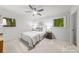 Inviting bedroom with neutral decor, ceiling fan, and large windows at 3519 Campbell Dr, Charlotte, NC 28205