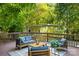Inviting outdoor deck featuring stylish seating, a coffee table, and lush green surroundings at 3519 Campbell Dr, Charlotte, NC 28205