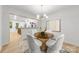 Stylish dining room with modern chandelier and view into the kitchen at 3519 Campbell Dr, Charlotte, NC 28205