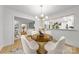Elegant dining room with modern lighting, glass table, and four chairs at 3519 Campbell Dr, Charlotte, NC 28205