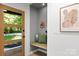 Bright entryway with a wooden door, bench seating, and decorative art at 3519 Campbell Dr, Charlotte, NC 28205