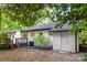 Exterior featuring a deck, mature landscaping, and updated paint, perfect for outdoor living at 3519 Campbell Dr, Charlotte, NC 28205