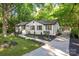 Charming single-story home featuring a manicured lawn, dark mulch beds, and a welcoming walkway to the front entrance at 3519 Campbell Dr, Charlotte, NC 28205