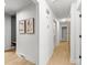 Bright hallway features sleek, hardwood floors and neutral decor, seamlessly connecting the home at 3519 Campbell Dr, Charlotte, NC 28205