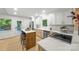 Well-lit kitchen with stainless steel appliances, quartz countertops, and island seating at 3519 Campbell Dr, Charlotte, NC 28205