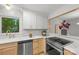 Bright kitchen boasts modern appliances, marble countertops, and charming light wood cabinets at 3519 Campbell Dr, Charlotte, NC 28205