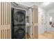 Efficient laundry area with modern stacked washer/dryer and storage, providing convenience and organization at 3519 Campbell Dr, Charlotte, NC 28205