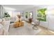 Spacious living room with hardwood floors, white furniture, and sunlit windows at 3519 Campbell Dr, Charlotte, NC 28205