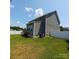 Landscaped backyard featuring a fence, patio, and green lawn at 3717 English Garden Dr, Gastonia, NC 28056