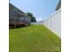 Expansive backyard featuring a manicured lawn and a pristine white fence at 3717 English Garden Dr, Gastonia, NC 28056