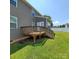 Backyard showcasing a wooden deck with steps and a well-maintained lawn at 3717 English Garden Dr, Gastonia, NC 28056