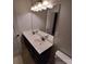 Bathroom featuring a dual sink vanity, a mirror, decorative lights, and tan colored tile flooring at 3717 English Garden Dr, Gastonia, NC 28056