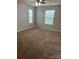 Cozy bedroom with neutral paint, a ceiling fan, and two windows at 3717 English Garden Dr, Gastonia, NC 28056