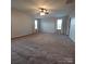 Spacious carpeted bedroom featuring a ceiling fan, neutral walls, and large windows for ample natural light at 3717 English Garden Dr, Gastonia, NC 28056
