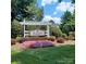Charming Rosegate community entrance sign surrounded by colorful flower beds and lush landscaping at 3717 English Garden Dr, Gastonia, NC 28056