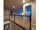 Bright hallway featuring neutral walls, plush carpet, and a stylish wooden railing, enhanced by natural light at 3717 English Garden Dr, Gastonia, NC 28056