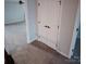 Neutral colored hallway with carpeting featuring a closet with double doors and access to multiple rooms at 3717 English Garden Dr, Gastonia, NC 28056