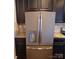 Stainless steel GE refrigerator is surrounded by dark cabinetry and granite countertops at 3717 English Garden Dr, Gastonia, NC 28056