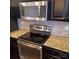A modern kitchen featuring stainless steel appliances, granite countertops, and stone backsplash at 3717 English Garden Dr, Gastonia, NC 28056