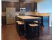 A modern kitchen featuring dark cabinets, stainless steel appliances, and a large granite island with seating at 3717 English Garden Dr, Gastonia, NC 28056