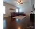 Cozy living room features hardwood floors, leather sofa, area rug and neutral walls at 3717 English Garden Dr, Gastonia, NC 28056