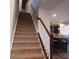 Carpeted staircase with white spindles and dark wood railing leads to the upper level of the home at 3717 English Garden Dr, Gastonia, NC 28056