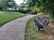 Scenic community walking path with lush landscaping and benches at 3717 English Garden Dr, Gastonia, NC 28056