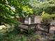 View of house featuring deck, porch, and exterior with lots of surrounding greenery at 3881 Wood Duck Ln, Denver, NC 28037