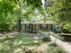 Charming single-story home featuring a covered front porch and lush landscaping at 3881 Wood Duck Ln, Denver, NC 28037