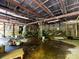 This is an interior shot of an old garage that has water damage and is full of debris at 3881 Wood Duck Ln, Denver, NC 28037