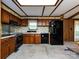 Kitchen with black appliances, wood cabinets, and a skylight at 3881 Wood Duck Ln, Denver, NC 28037