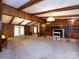 Spacious living room featuring wood beams, a fireplace, and carpet flooring at 3881 Wood Duck Ln, Denver, NC 28037