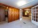 Living room with wood walls and view to dining room offers space and character at 3881 Wood Duck Ln, Denver, NC 28037