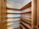 Pantry with wood shelves provides storage and organization at 3881 Wood Duck Ln, Denver, NC 28037