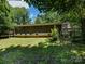 View of backyard and screened in porch surrounded by trees at 3881 Wood Duck Ln, Denver, NC 28037