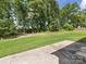 Green backyard featuring healthy green grass with patio space to relax in the great outdoors at 4014 Stockbrook Dr, Charlotte, NC 28215