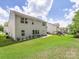 Extensive backyard showcasing lush grass, a playset, and the rear facade of the house at 4014 Stockbrook Dr, Charlotte, NC 28215