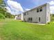 Spacious backyard offering ample green space, a well-maintained lawn, and the home's rear exterior at 4014 Stockbrook Dr, Charlotte, NC 28215
